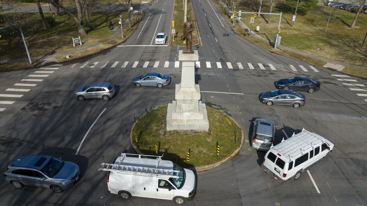 Traffic drives in the circle at the monument of confederate General A.P. Hill, which contains his remains, is in the middle of a traffic circle on Arthur Ashe Blvd. Jan. 6, 2022, in Richmond, Va. Richmond officials are seeking a court order to move the only remaining Confederate monument owned by the city. The Richmond City Council voted unanimously Monday, May 9, 2022 to direct the city administration to grant the statue of Confederate Gen. A.P. Hill to the Black History Museum and Cultural Center of Virginia, The Richmond Times-Dispatch reported. (AP Photo/Steve Helber)