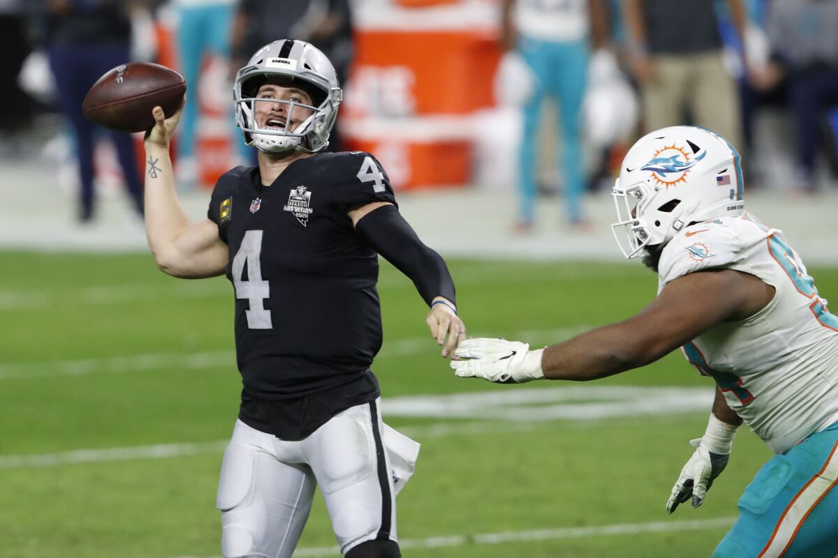 Raiders quarterback Derek Carr throws against the Dolphins during the second half Dec. 26, 2020.