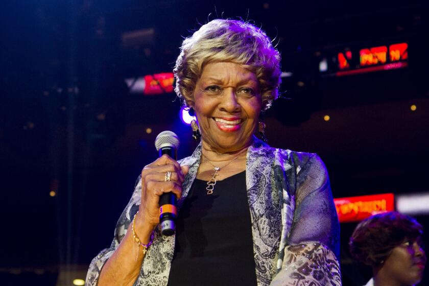 Cissy Houston smiles while holding a microphone in 2013