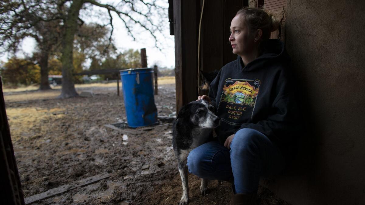 Megan Brown of Oroville evacuated at the last minute as flames from the Camp fire approached her property, but she stayed nearby to feed the animals she could not evacuate.