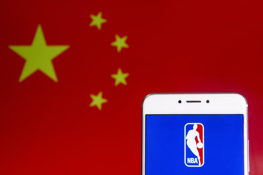 HONG KONG - 2019/04/06: In this photo illustration a American National Basketball Association (NBA) men's professional basketball league logo is seen on an Android mobile device with People's Republic of China flag in the background. (Photo Illustration by Budrul Chukrut/SOPA Images/LightRocket via Getty Images)
