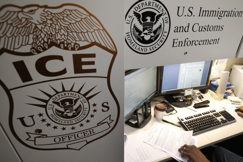 LAGUNA NIGUEL, CALIF. -- WEDNESDAY, APRIL 26, 2017: An unidentified Immigration and Customs Enforcement, ICE deportation officer reviews forms required to issue a detainer asking local law enforcement to hold someone until ICE agents can pick the person up, at the the Pacific Enforcement Response Center in Laguna Niguel Wednesday, April 26, 2017. When someone is arrested and booked into custody anywhere in the U.S., their fingerprints are sent electronically into a FBI database. Immigration agents can access the FBI database and working 24/7 they cross check prints against ICE's own databases of people suspected of being in the country illegally. When there is a hit, ICE notifies the local police that they want to take custody of the suspected illegal immigrant. The nerve center of this electronic sleuthing is a non-descript government building in Laguna Niguel where ICE agents sit at computer terminals trolling for matches. Photos taken in Laguna Niguel, Calif., on April 26, 2017. (Allen J. Schaben / Los Angeles Times)