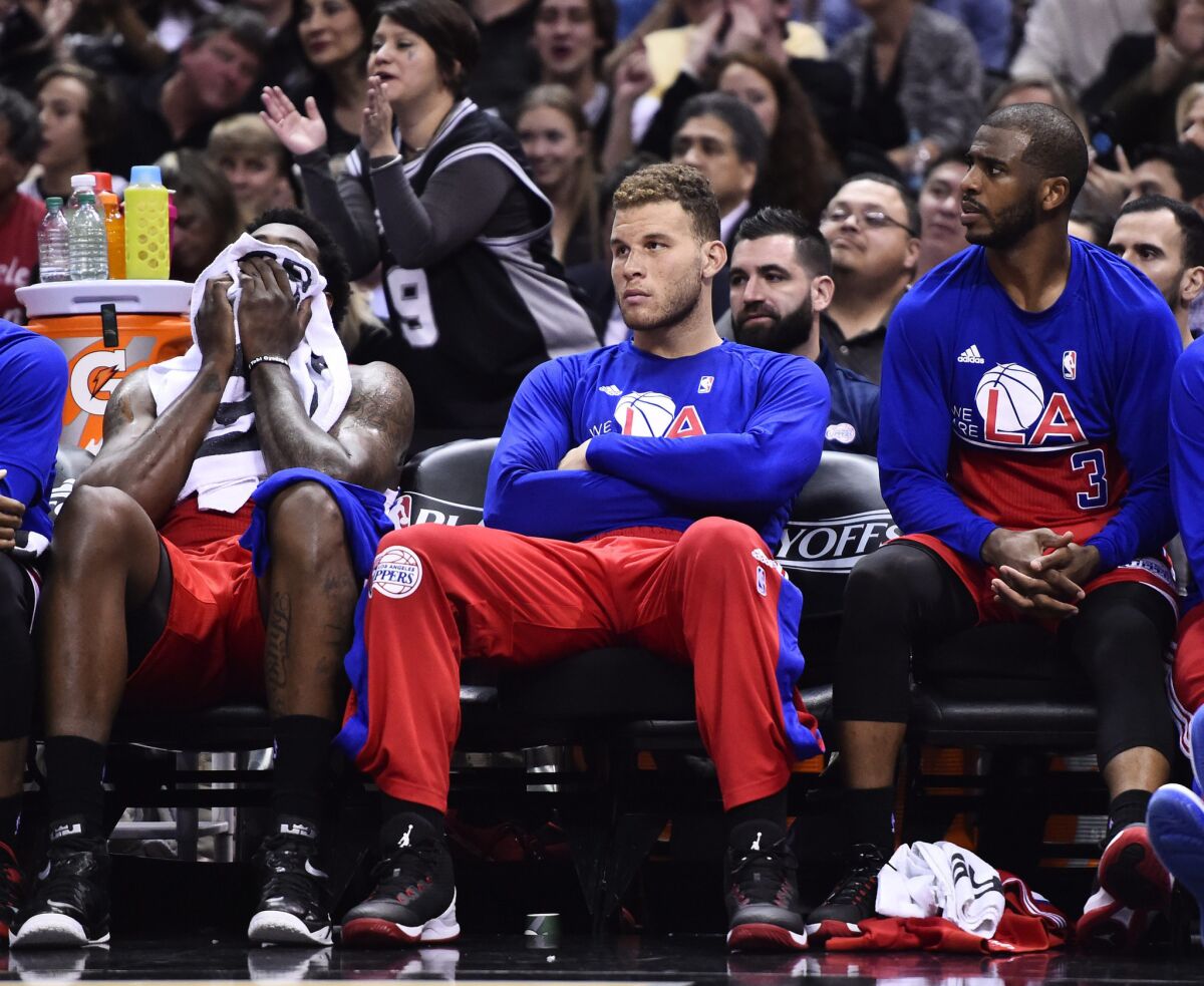 Clippers starters (from left) DeAndre Jordan, Blake Griffin and Chris Paul watch from the bench during the fourth quarter of Game 3.