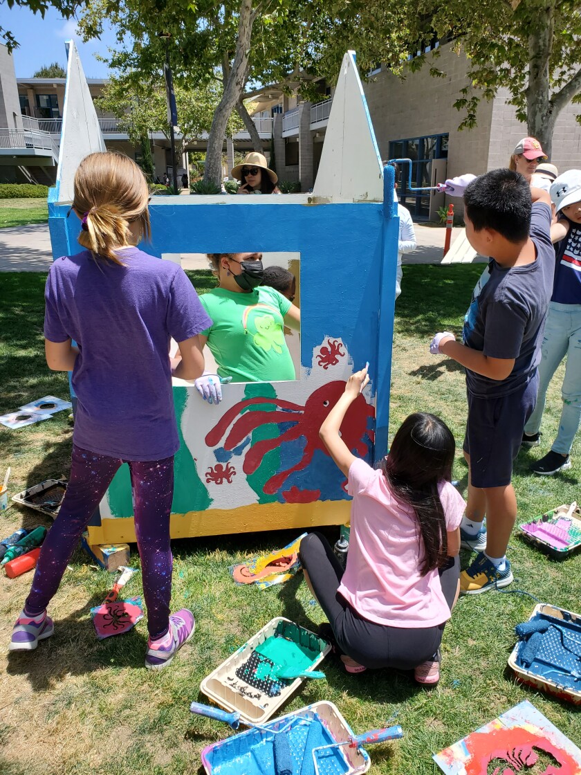La Jolla Country Day School fifth-graders paint a partially constructed ocean-themed playhouse.