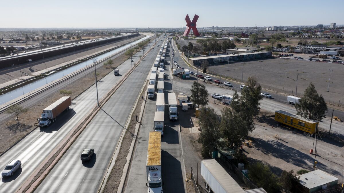 A long line of trucks is seeing stalled at the Bridge of the Americas, one of two ports of entry in Ciudad Juarez going into the U.S.on April 12, 2022. The truckers have seen prolonged processing times implemented by Gov. Abbott which they say have increased from 2-3 hours up to 14 hours in the last few days. (Omar Ornelas /The El Paso Times via AP)