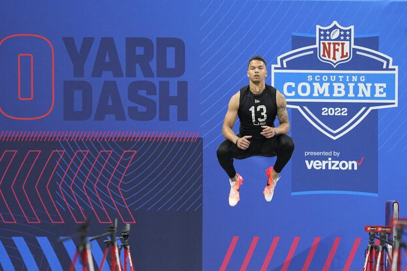 Cincinnati quarterback Desmond Ridder jumps before he runs the 40-yard dash during.