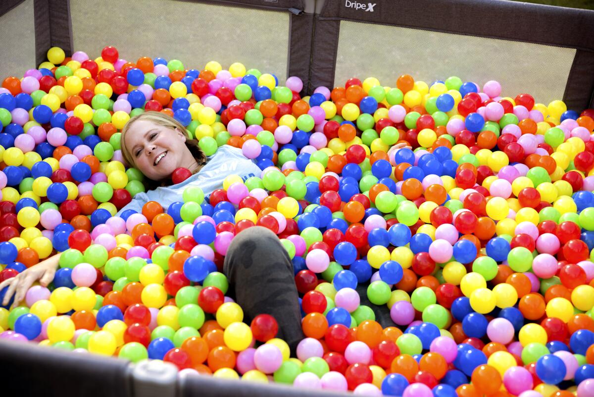 A woman in a multicolored ball pit