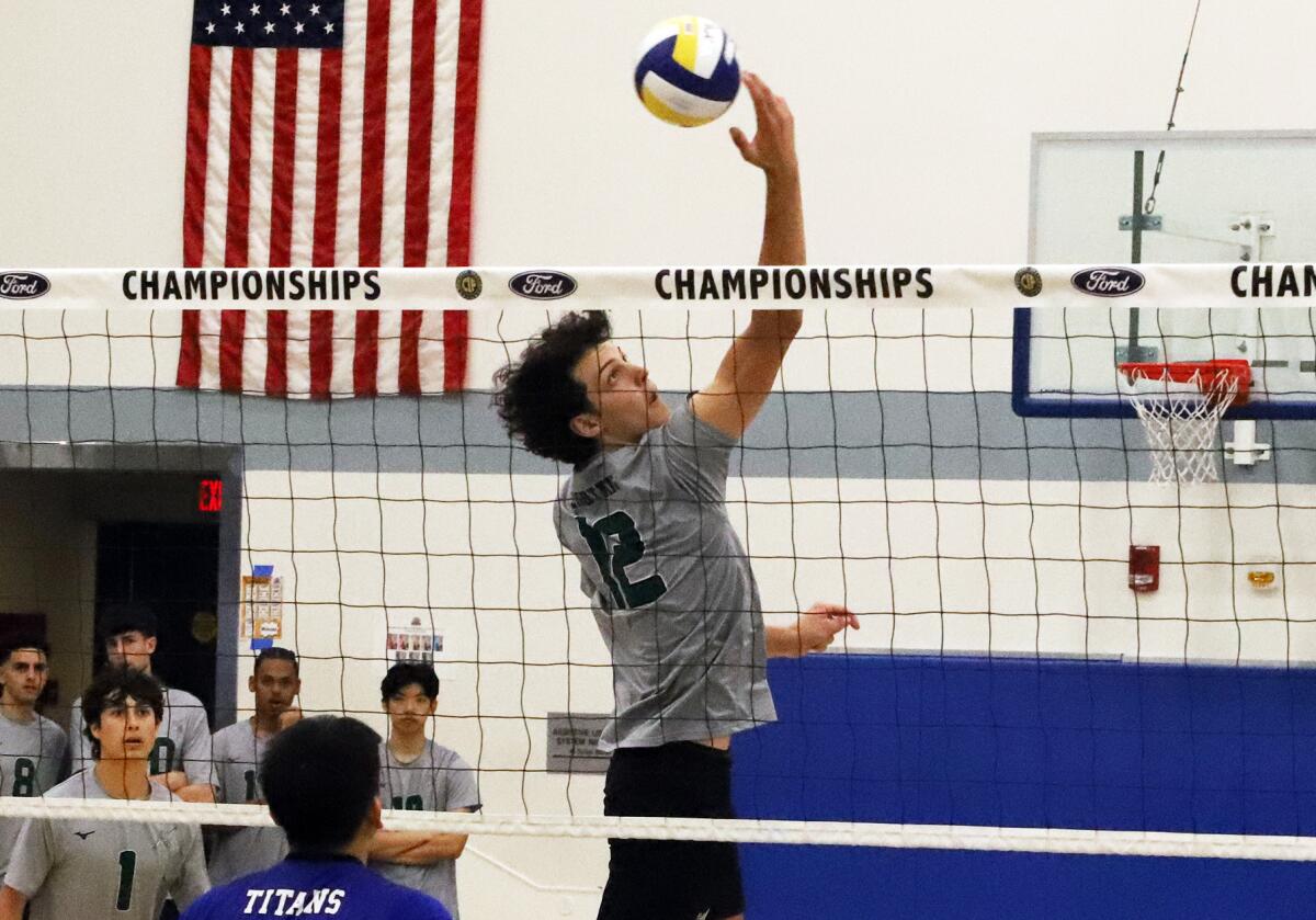 Sage Hill's Jackson Cryst (12) backhands the ball over the net against San Marino in the CIF Division 5 final.