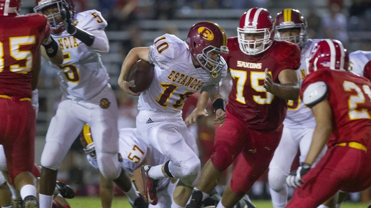 Estancia High's Trevor Pacheco, shown running the ball against Loara on Aug. 31, 2017, faces the Saxons for the second straight year on Friday.