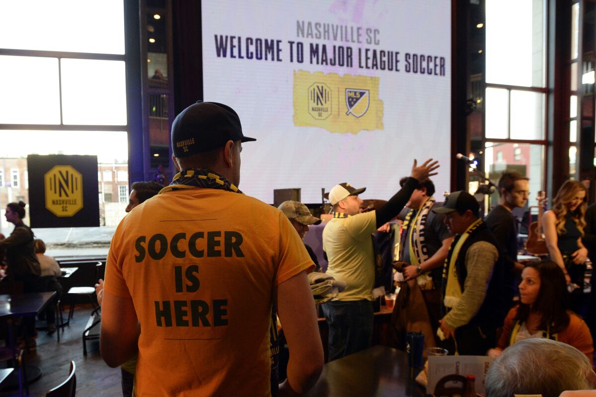 A Nashville SC fan looks for a seat before the start of the MLS expansion draft Nov. 19.