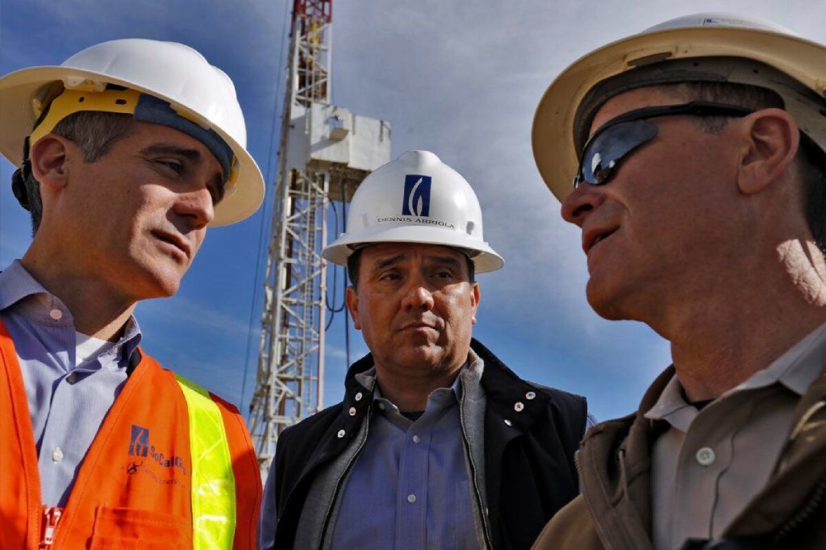 Los Angeles Mayor Eric Garcetti, left, visits the Aliso Canyon gas storage facility with then-CEO Dennis Arriola of Southern California Gas Co. and the company's current chief executive, Bret Lane, right, on Dec. 2, 2015.