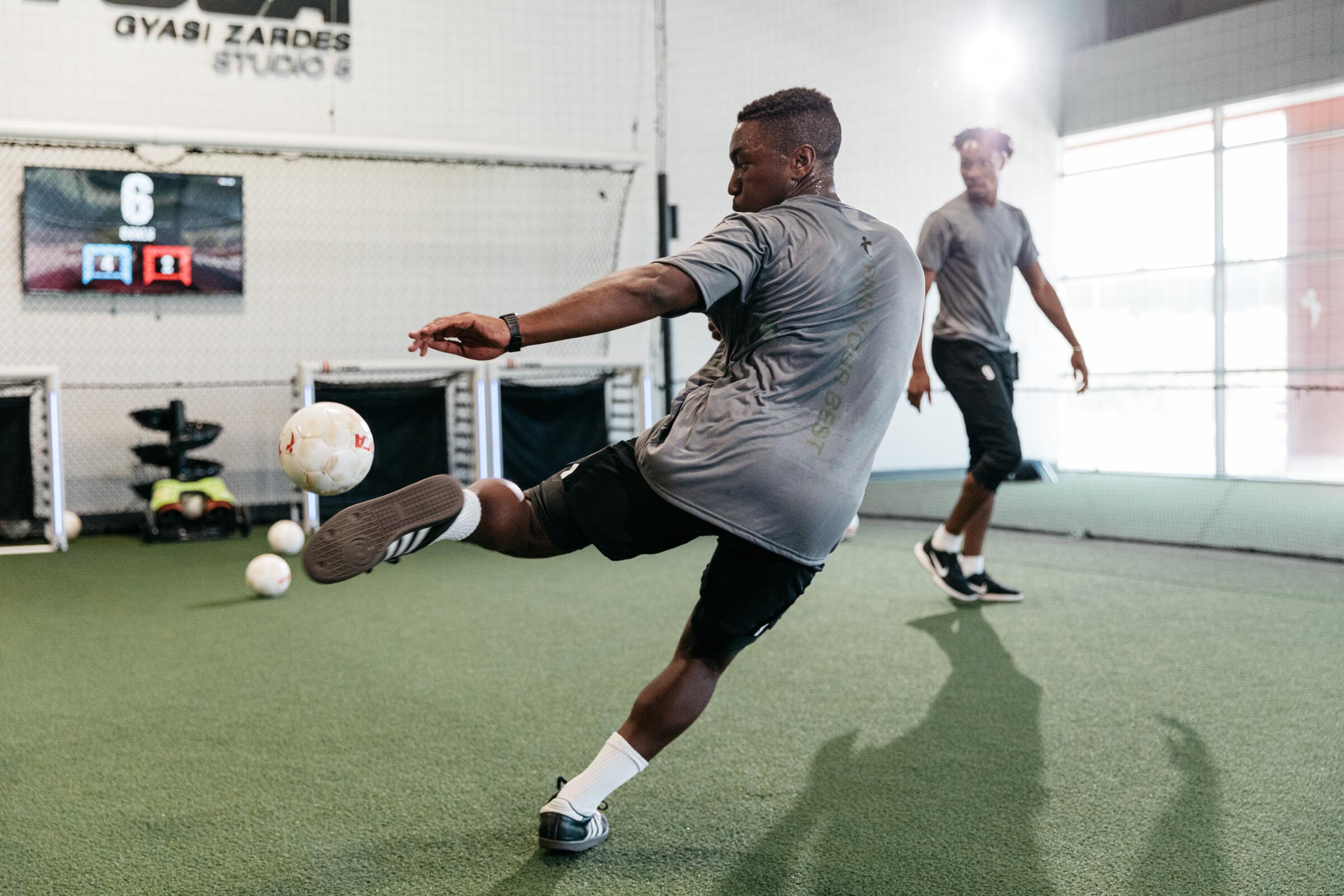 A soccer player takes a volley from the TOCA Touch Trainer at TOCA Football’s training facility in Costa Mesa.