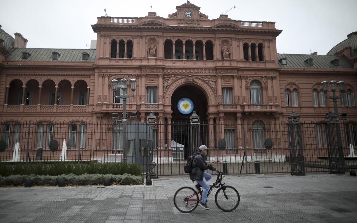Man on bicycle in front of government house in Buenos Aires