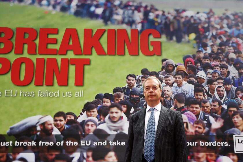 Right-wing parliament member Nigel Farage poses during the Brexit campaign in front of a poster depicting a crowd of refugees ostensibly headed for Britain. The poster was widely condemned.