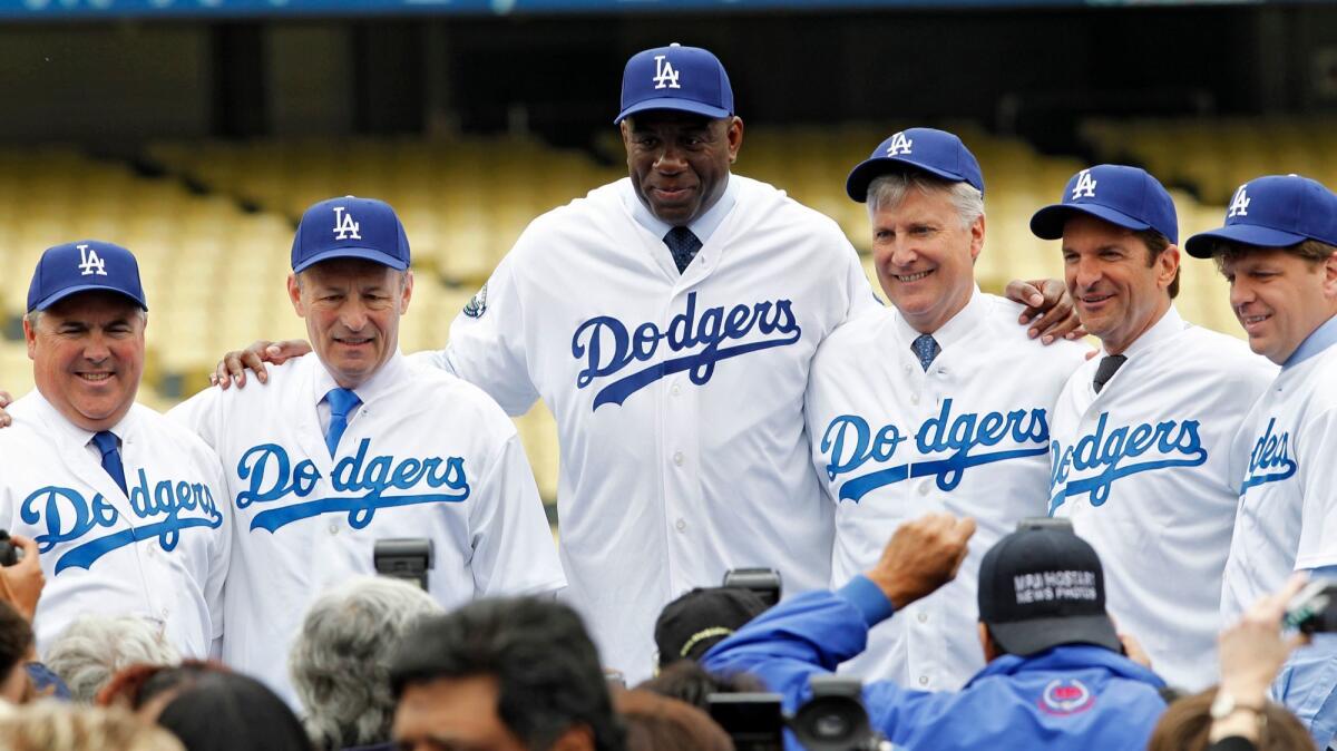 The Guggenheim Baseball Management group -- Bobby Patton, from left, Stan Kasten, Magic Johnson, Mark Walter, Peter Guber and Todd Boehly -- poses for photos at Dodger Stadium on May 2, 2012.