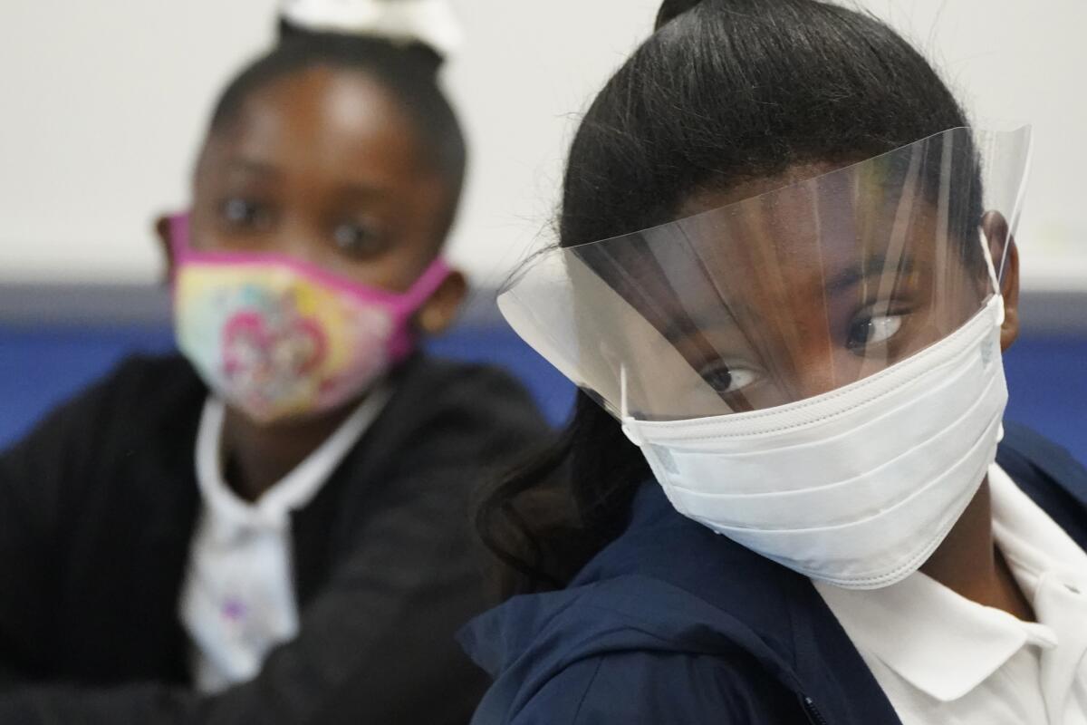 Fifth-grade students wear masks in class