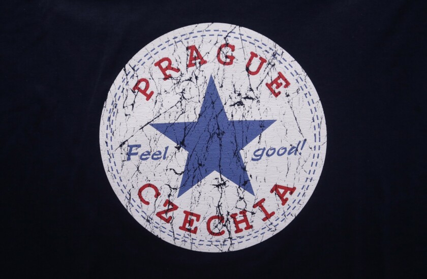 A sign with the word "Czechia" is printed on a T-shirt displayed in a store in Prague, Czech Republic.