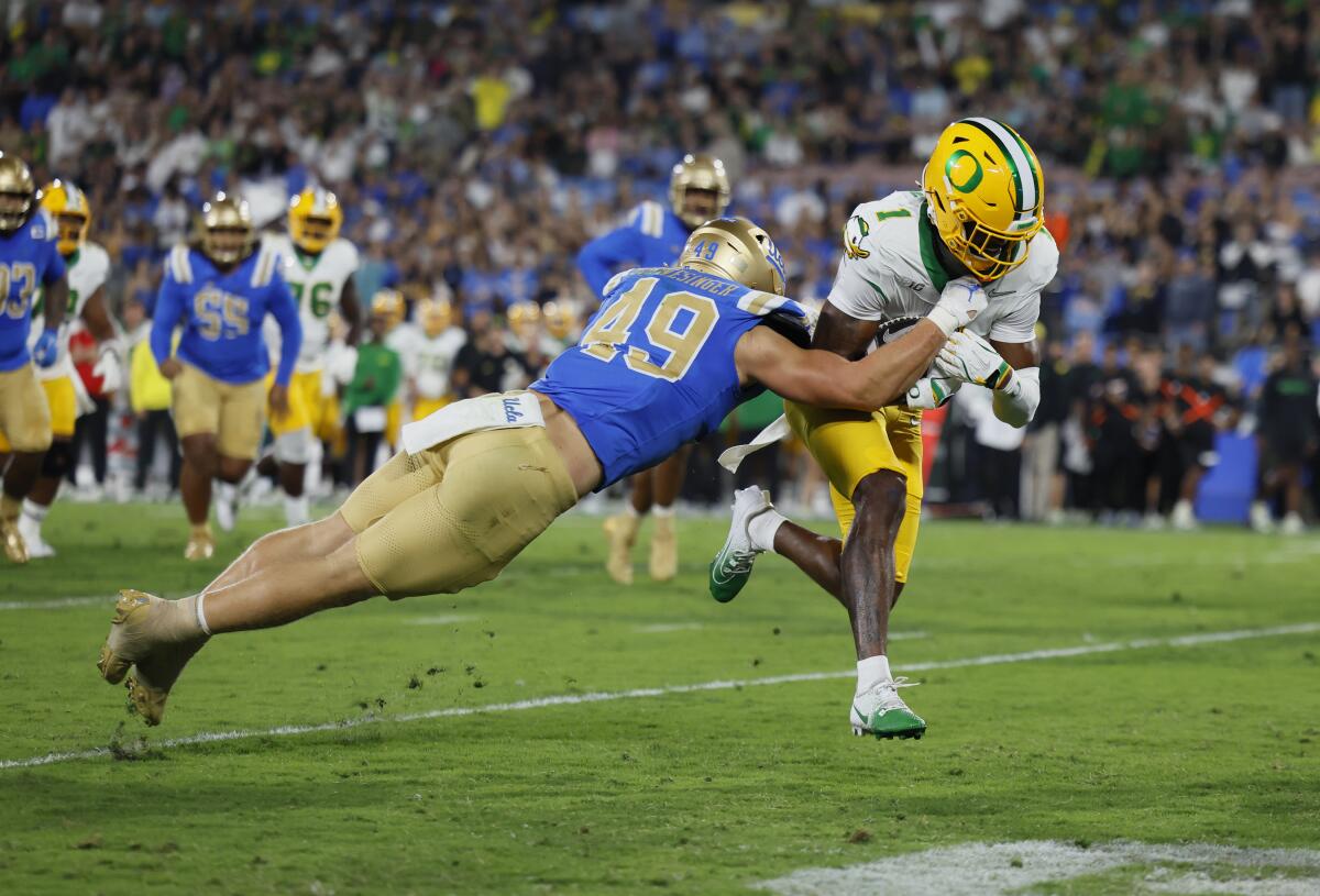 Can UCLA salvage its season? 5 issues to look at when the Bruins face Minnesota 1 UCLA linebacker Carson Schwesinger tries to stop Oregon receiver Traeshon Holden as he runs into the end zone