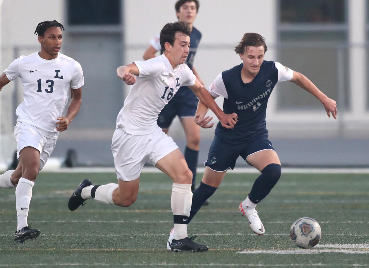 Newport Harbor's James Evans (6) battles for the ball against Loyola's Andrew Sullivan on Friday.