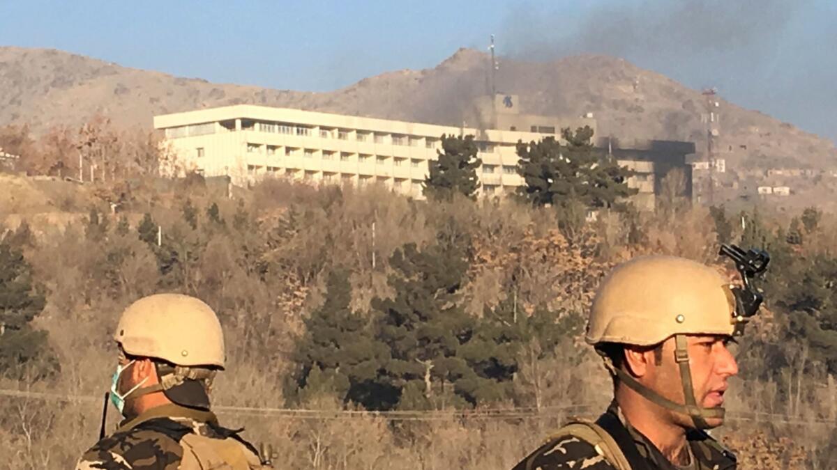 Smokes rises from the Intercontinental Hotel early Sunday morning in Kabul, Afghanistan. Gunman stormed the hotel on Saturday evening, triggering a shootout with security forces.