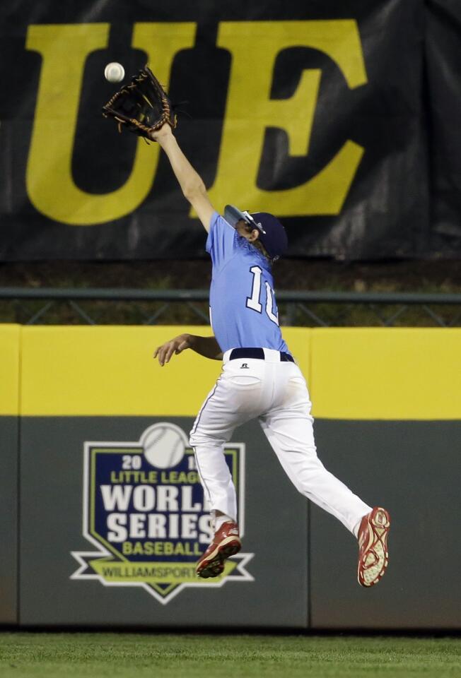 Preston Fleming, of Sweetwater Valley, cannot catch an RBI single by Tayshaun Jones, of Bowling Green, Ky., during the fifth inning.