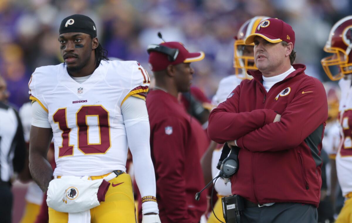 Washington quarterback Robert Griffin III, left, stands on the sidelines with Coach Jay Gruden in November.