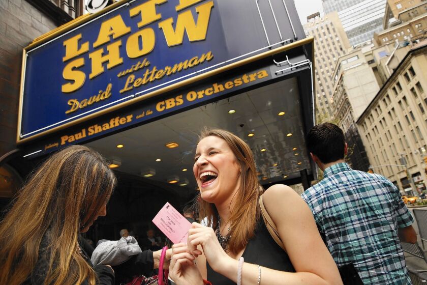 Jordan Bautsch, right, an 18-year-old from Reading, Pa., waits in line with ticket in hand to attend Wednesday’s “Late Show.”