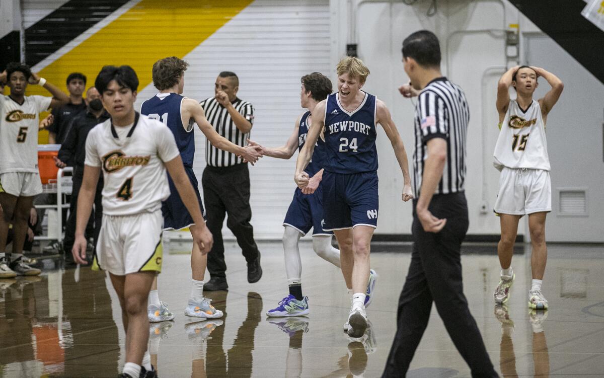 Newport Harbor's Adam Gaa, center, celebrates during a  playoff game against Cerritos on Friday.