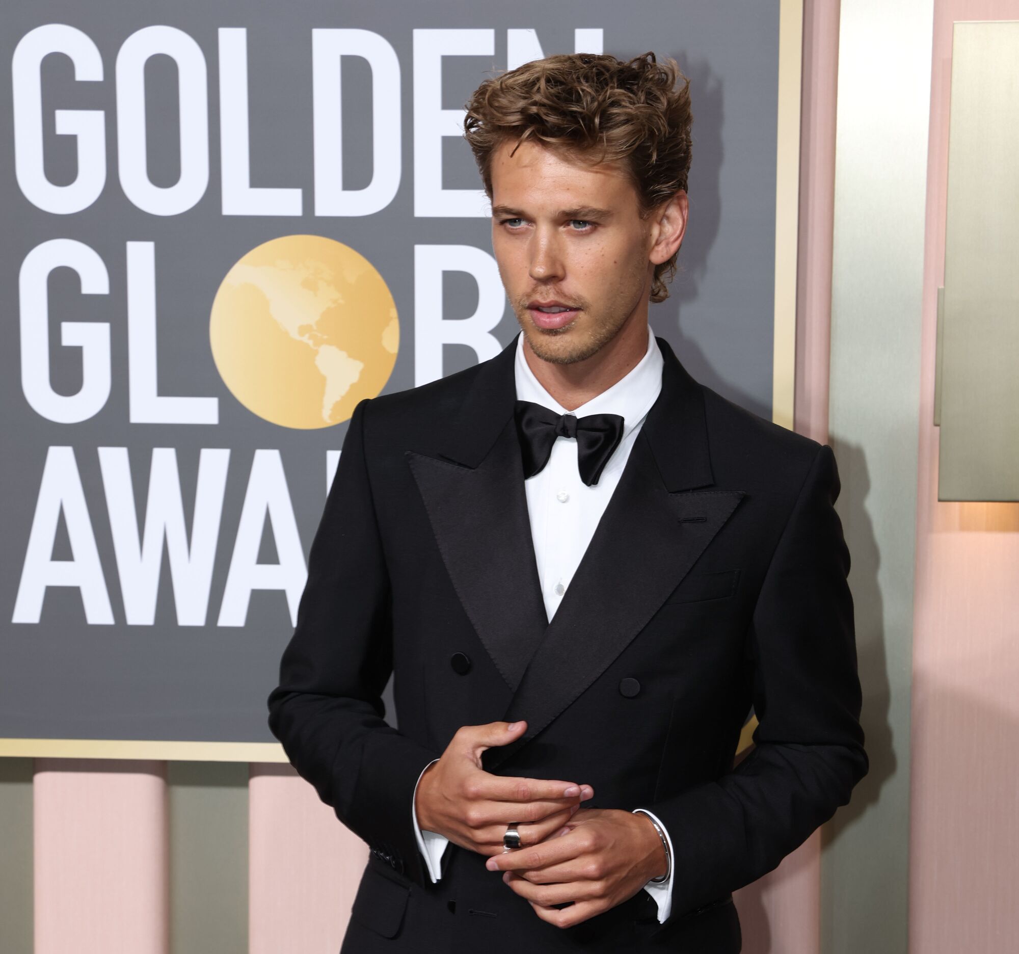 Austin Butler poses in a black tuxedo at the Golden Globes.
