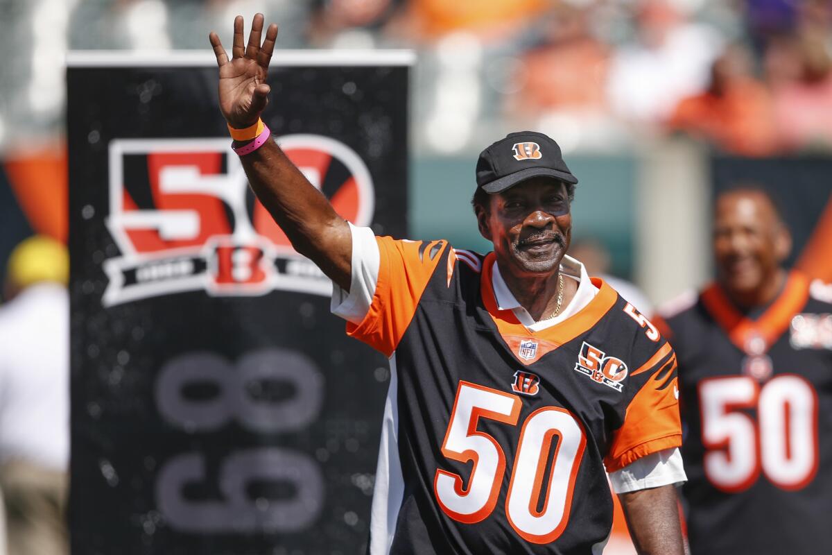 Former Cincinnati Bengals cornerback Ken Riley waves to the crowd during an on-field ceremony.