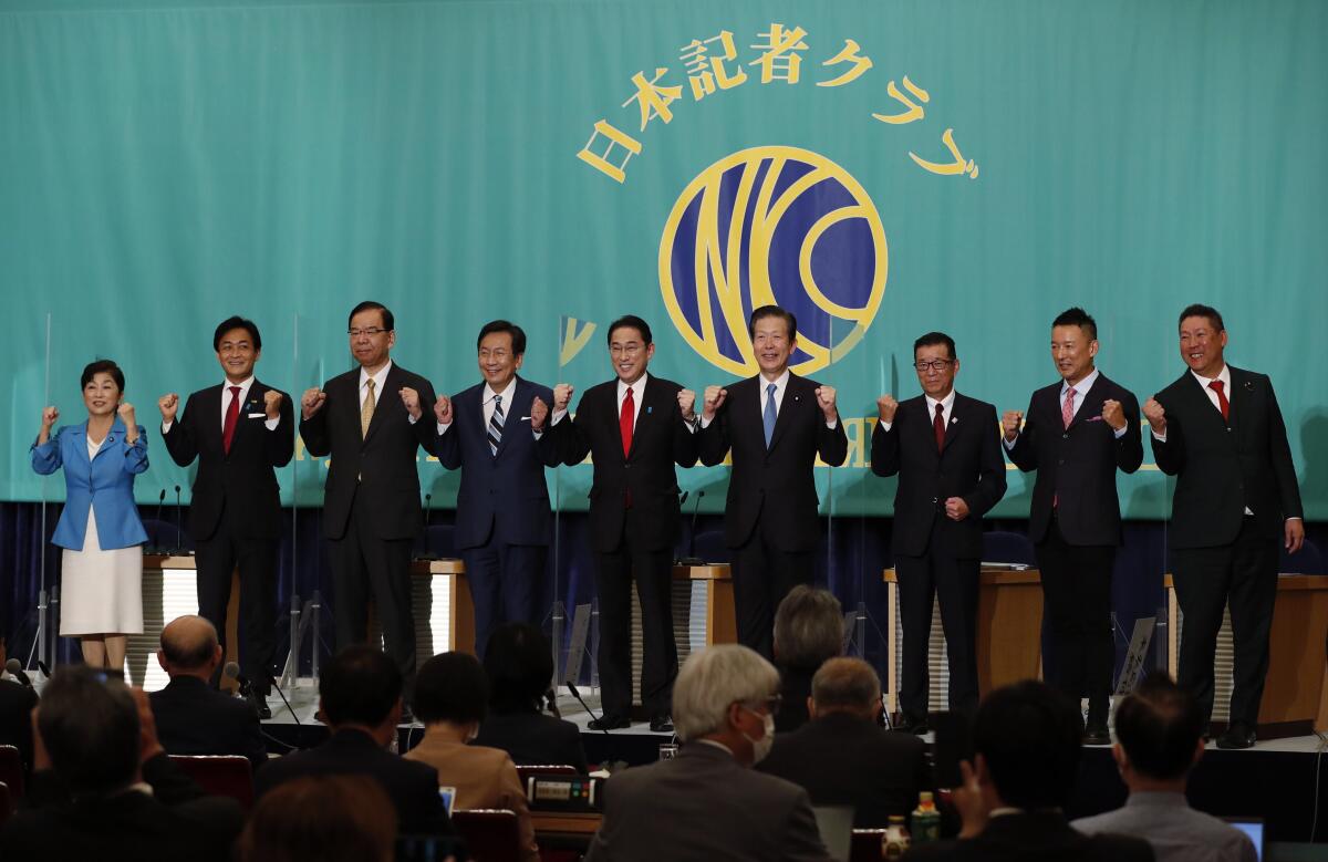 Leaders of Japan's main political parties, from left, the Social Democratic Party head Mizuho Fukushima, the Democratic Party for the People leader Yuichiro Tamaki, the Japanese Communist Party Chairman Kazuo Shii, the Constitutional Democratic Party of Japan leader Yukio Edano, Japan's Prime Minister and ruling Liberal Democratic Party President Fumio Kishida, Komeito party leader Natsuo Yamaguchi, The Japan Restoration Party, also known as the Japan Restoration Association, leader Ichiro Matsui, Reiwa Shinsengumi party leader Taro Yamamoto and leader of the party fighting against NHK in the trial for violating Article 72 of the Attorney Act Takashi Tachibana pose for a photograph at the start of debate session ahead of Oct. 31, 2021 lower house election, at the Japan National Press Club in Tokyo Monday, Oct. 18 , 2021. (Issei Kato/Pool Photo via AP)