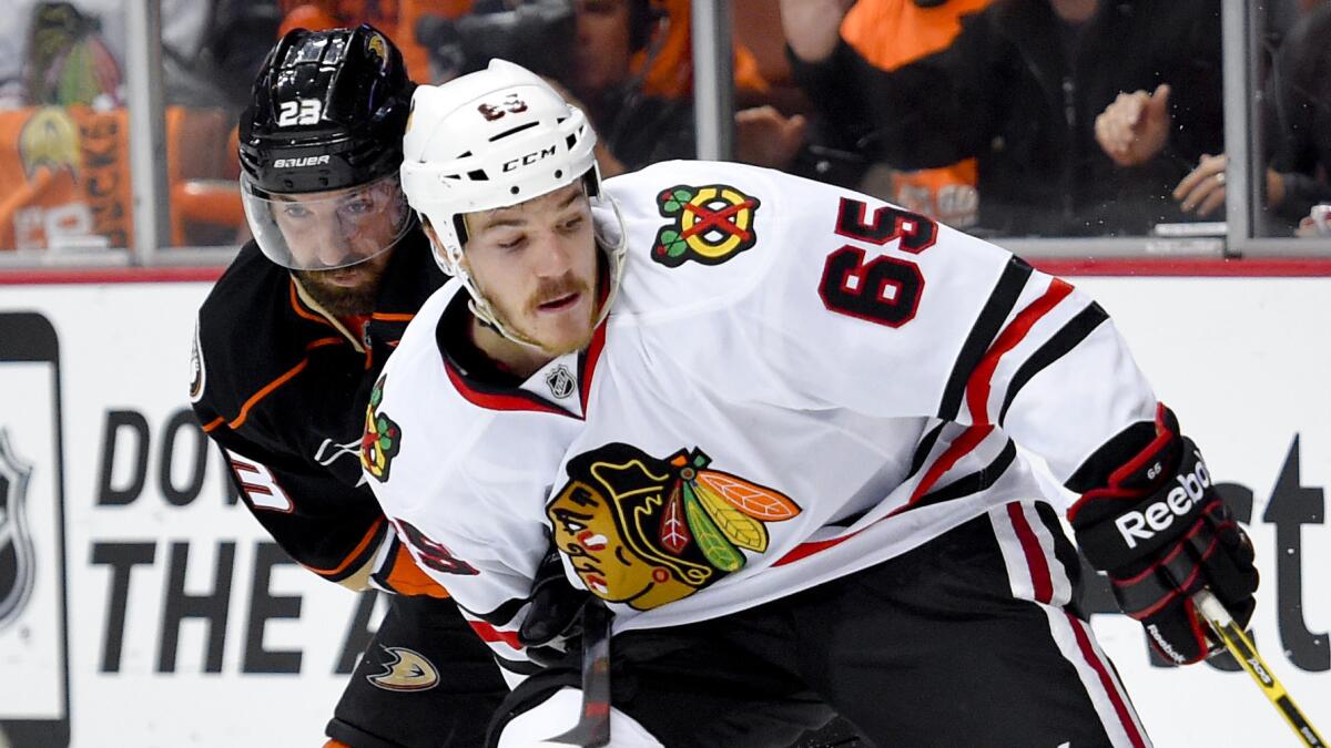 Chicago Blackhawks center Andrew Shaw (65) controls the puck in front of Ducks defenseman Francois Beauchemin during the Ducks' 3-2 loss in Game 2 of the Western Conference finals at Honda Center on May 19, 2015.