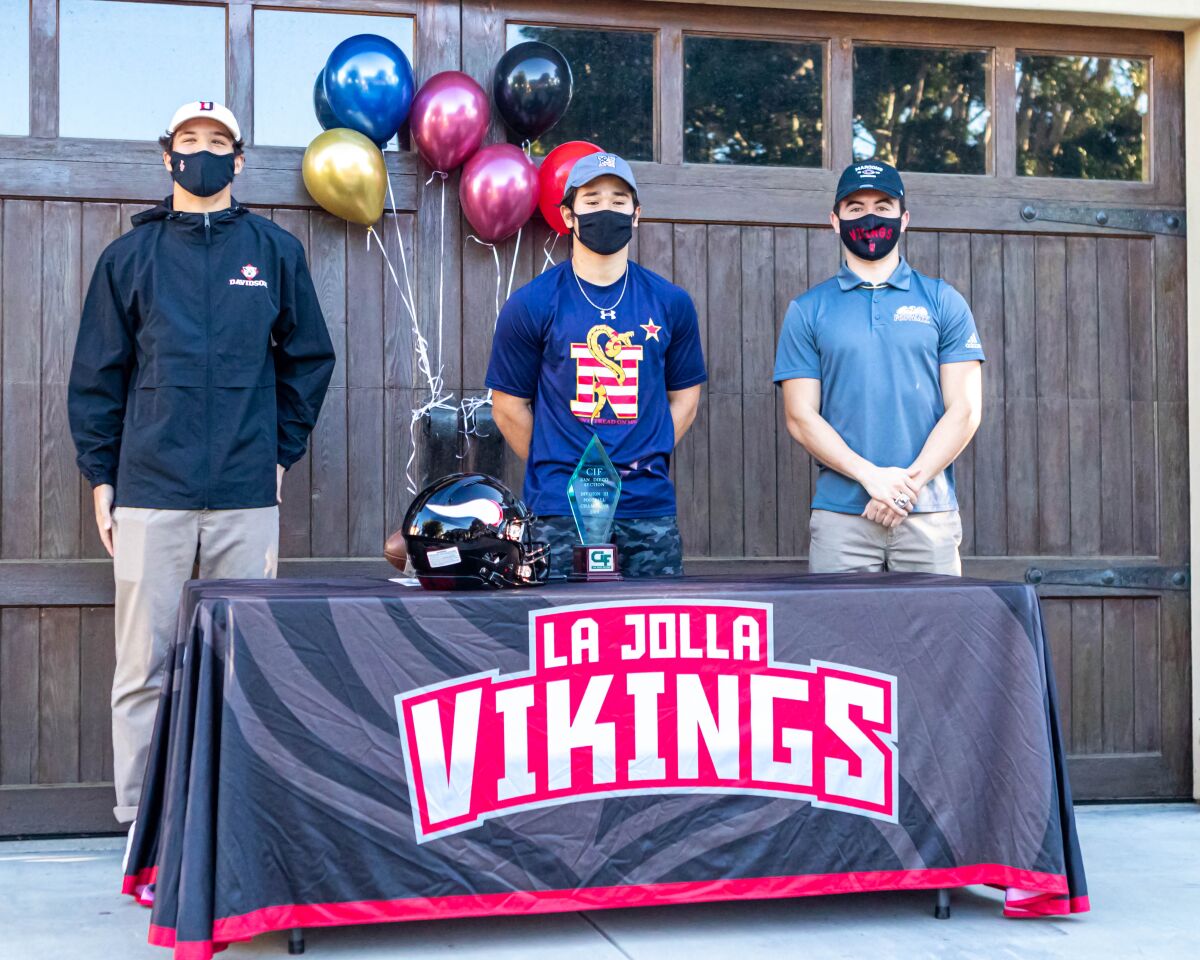 Viking football players (from left) Alessandro Demoreno, Max Smith and Diego Solis sign letters of intent.