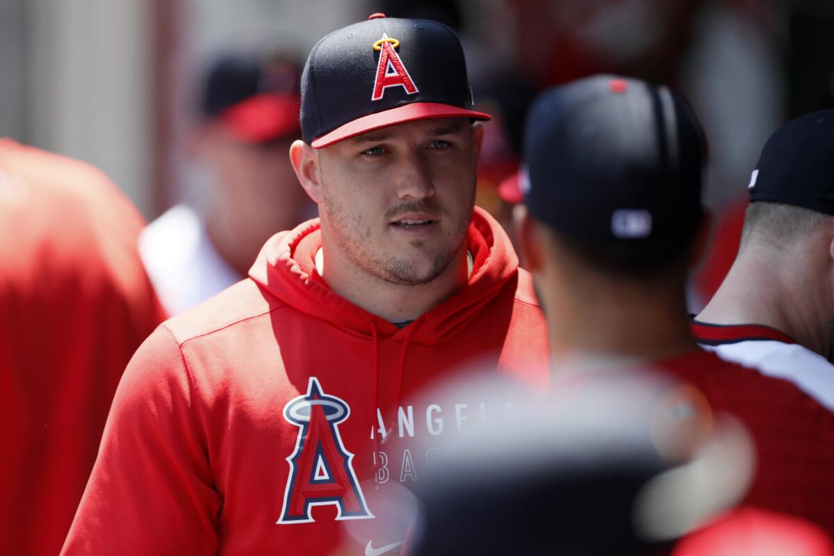 FILE - In this July 31, 2021, file photo, Los Angeles Angels' Mike Trout talks with a teammate before their baseball game against the Oakland Athletics in Anaheim, Calif. Trout missed his 67th game Tuesday night, Aug. 3, since going on the injured list May 18 with a right calf strain. This is only the third time he has been on the injured list in his 11 big league seasons, and his longest stretch missing games. (AP Photo/Alex Gallardo, File)