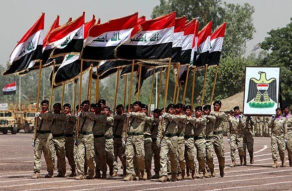 Iraqi forces march with their national colors.