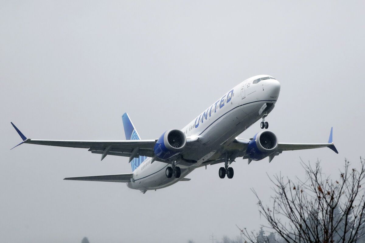 FILE - In this Dec. 11, 2019, file photo, an United Airlines Boeing 737 Max airplane takes off in the rain at Renton Municipal Airport in Renton, Wash. United Airlines said Friday, Feb. 14, 2020, that it is removing the grounded Boeing 737 Max from its schedule until early September, forcing it to cancel thousands more flights. (AP Photo/Ted S. Warren, File)