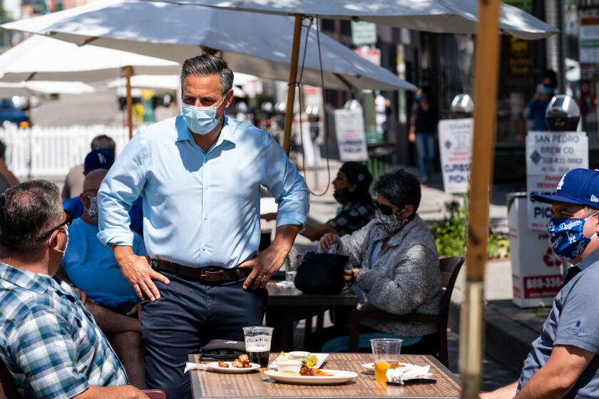 SAN PEDRO, CA - MAY 29: Council member Joe Buscaino of the 15th district, speaks with people dining at a section of Sixth Street is closed down between Mesa and and Centre streets in San Pedro where seating for dining is on Friday, May 29, 2020 in San Pedro, CA. On Friday, Los Angeles County received permission to reopen restaurants for in-person dining and resume services at barbershops and hair salons, marking a new phase in the regions efforts to restart the devastated retail economy. (Kent Nishimura / Los Angeles Times)