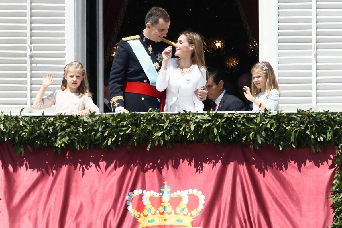 Spain's new King Felipe VI and Queen Letizia appear on a balcony at the Royal Palace in Madrid with daughters Princess Leonor, left, and Princess Sofia.