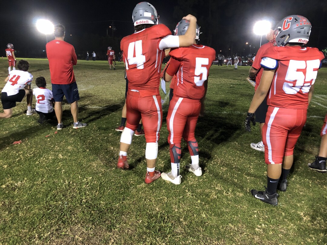 Brothers Trevin (4) and Kaden Adams (5) celebrate on the sideline during CSDR's playoff win on Nov. 6, 2021.