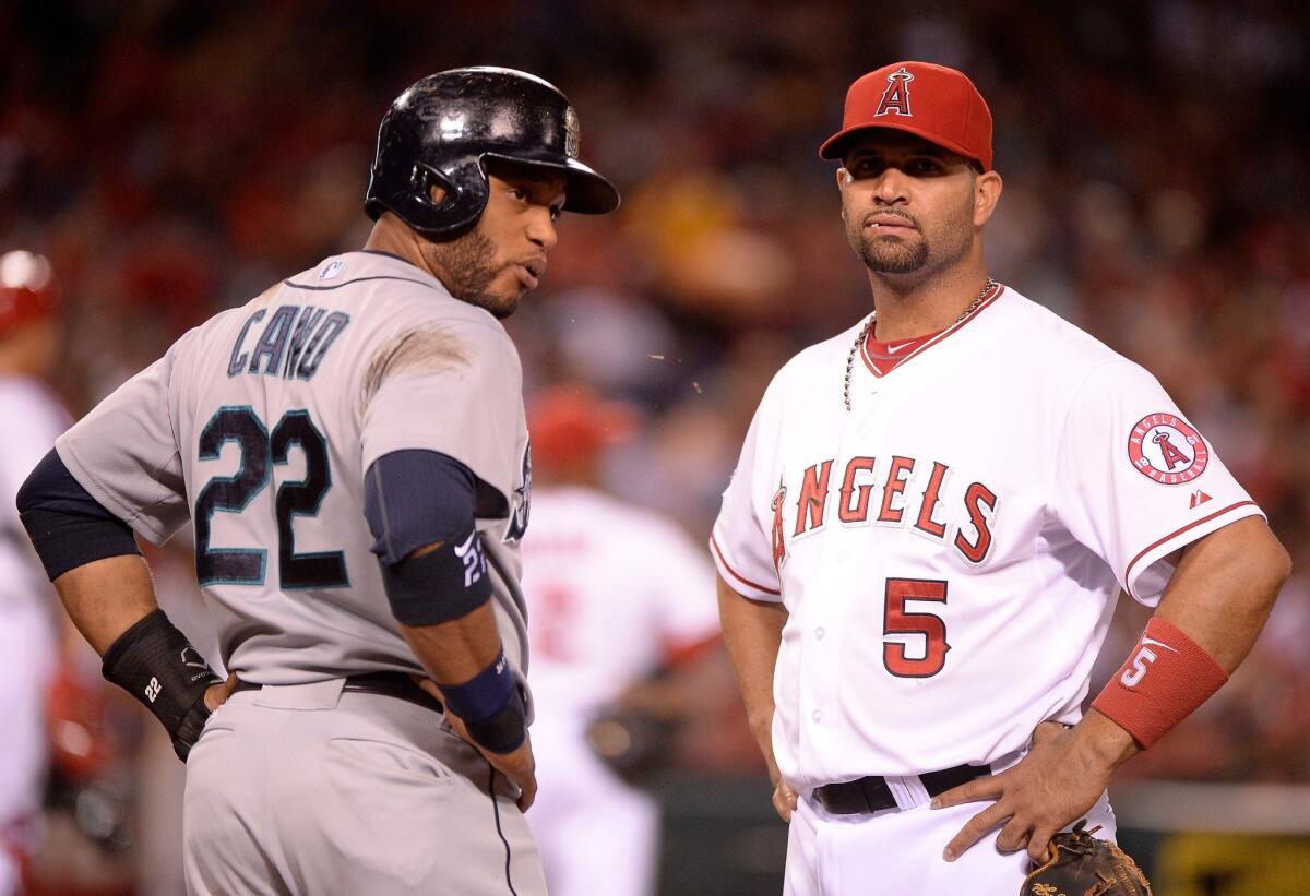 Seattle second baseman Robinson Cano and Angels first baseman Albert Pujols talk during a pitching change in the seventh inning. The Angels defeated the Mariners with a walk-off run in the 16th inning.