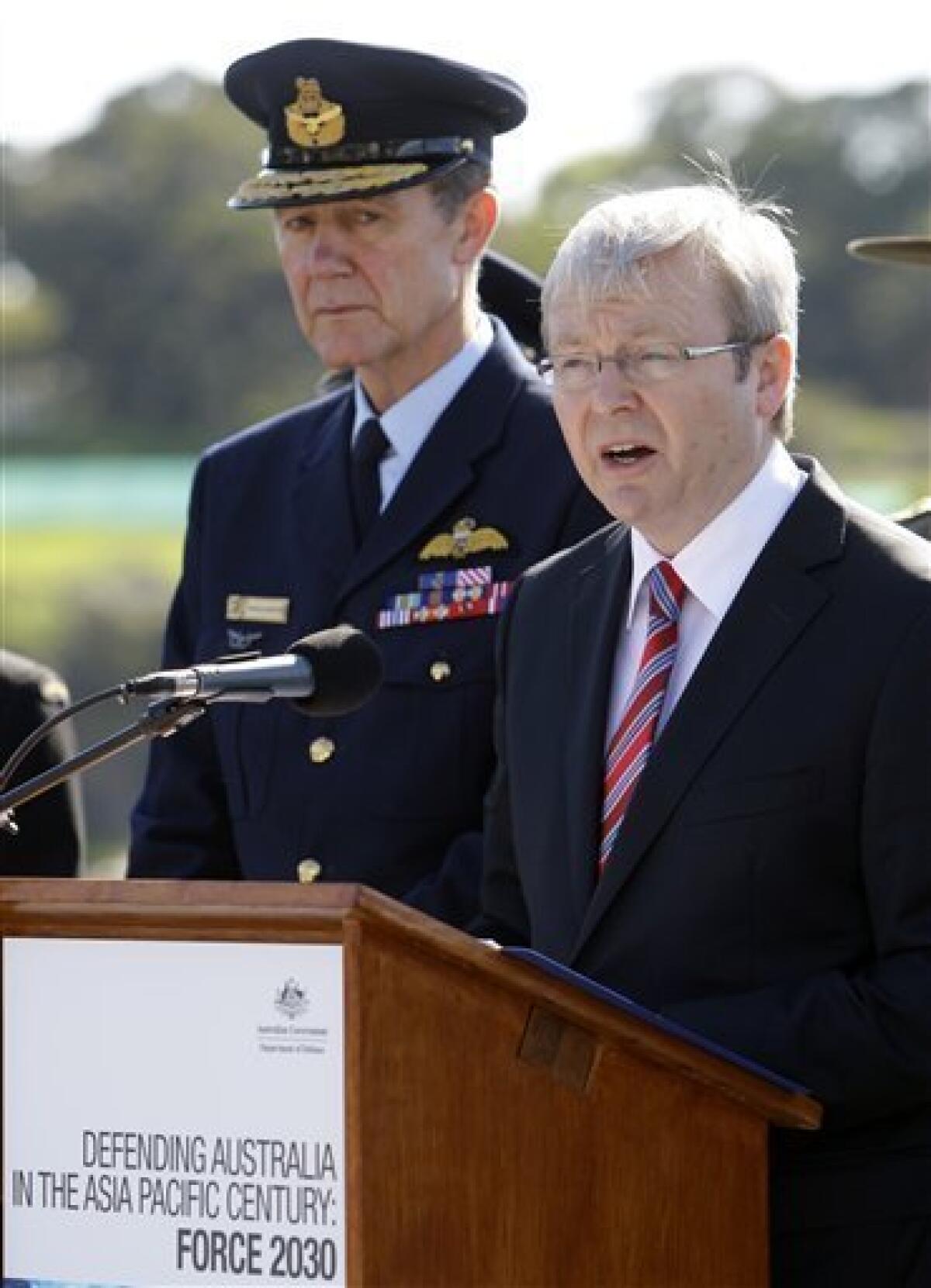 Prime Minister Kevin Rudd, right, announces the government's defense white paper as Chief of the Defense Force Angus Houston, left, looks on, aboard HMAS Stuart at Garden Island naval base in Sydney, Australia, Saturday, May 2, 2009. Its 140-page white paper - Defending Australia in the Asia Pacific Century: Force 2030, released on Saturday - outlines defense and strategic planning and signals what the government calls a major new direction aimed at building a "heavier" naval, air combat and logistics capability in the Asia Pacific. (AP Photo/Rick Rycroft)
