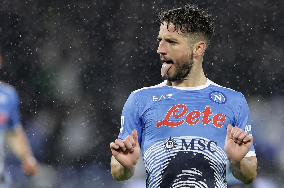 Napoli's Dries Mertens sticks his tongue out as he celebrates after scoring his side's second goal, during the Serie A soccer match between Napoli and Lazio, at the Diego Armando Maradona stadium in Naples, Italy, Sunday, Nov. 28, 2021. (Alessandro Garofalo/LaPresse via AP)