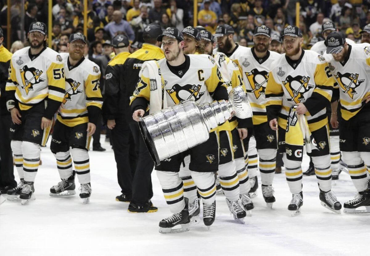 Pittsburg Penguins center Sidney Crosby holds the Stanley Cup after his team's victory over the Nashville Predators in Game 6 of the Stanley Cup Finals.