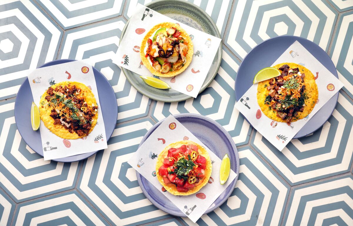 Four plates, each with a taco, at LA Cha Cha Cha