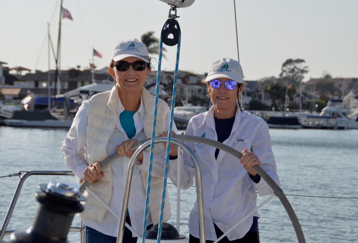 Assistant coach Gena Reed and coach Jane Hoffner check out a boat docked at the BYC.