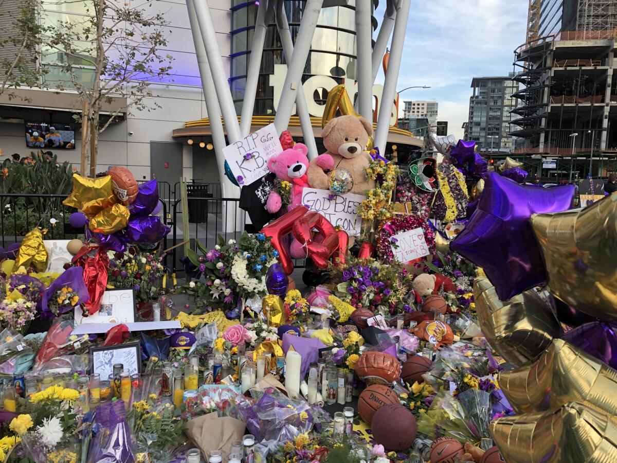 Tributes to Kobe Bryant, his daughter Gianna and the other seven victims of a helicopter crash Sunday that killed the Lakers legend are seen outside Staples Center and L.A. Live.