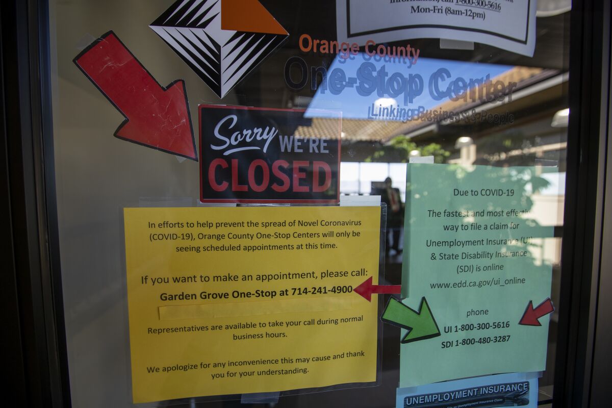 Signs are posted in May on the doors of the Orange County One-Stop Center in Garden Grove.