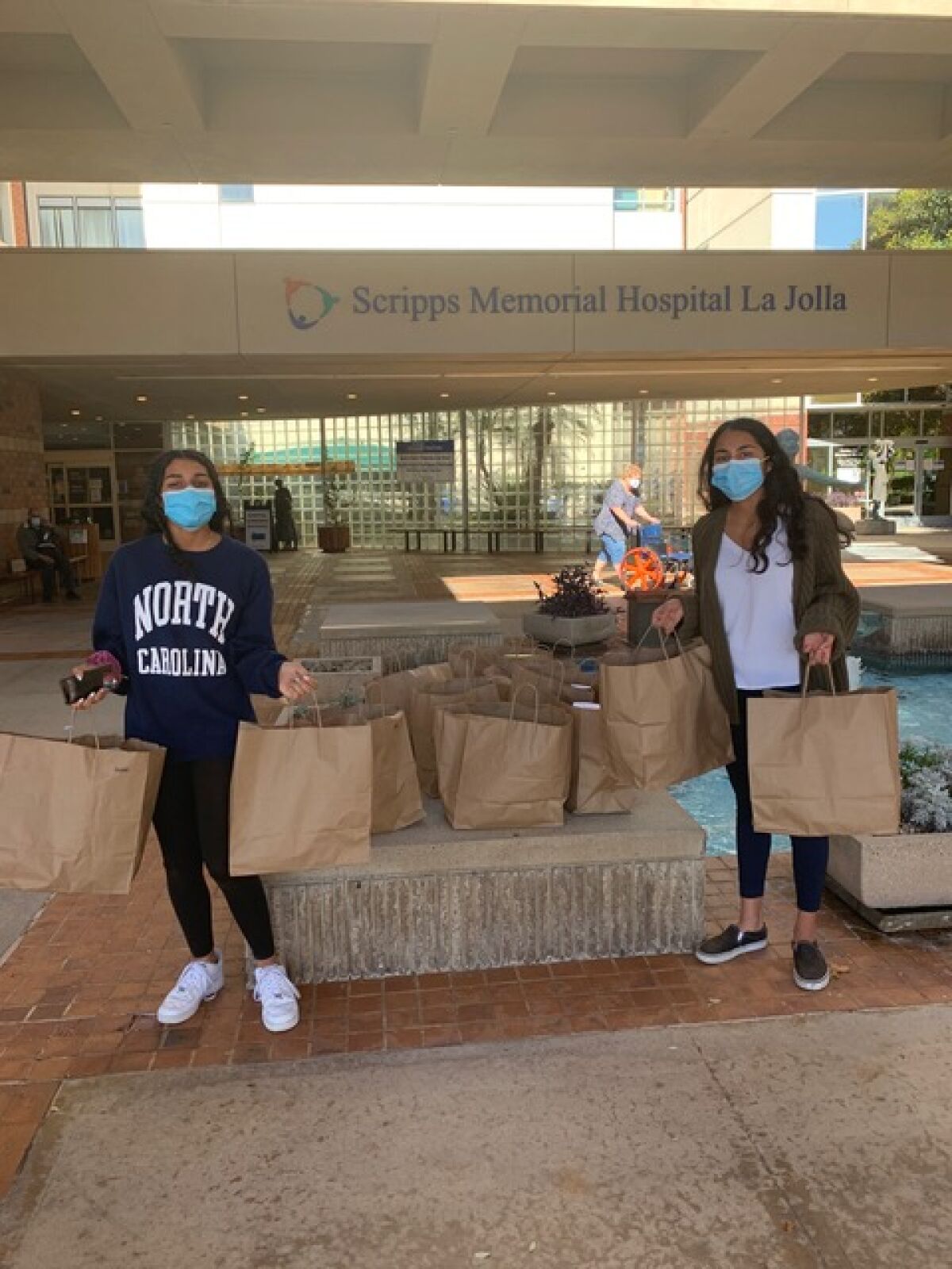 Mira and Bela Gowda make a food delivery to Scripps Memorial Hospital.