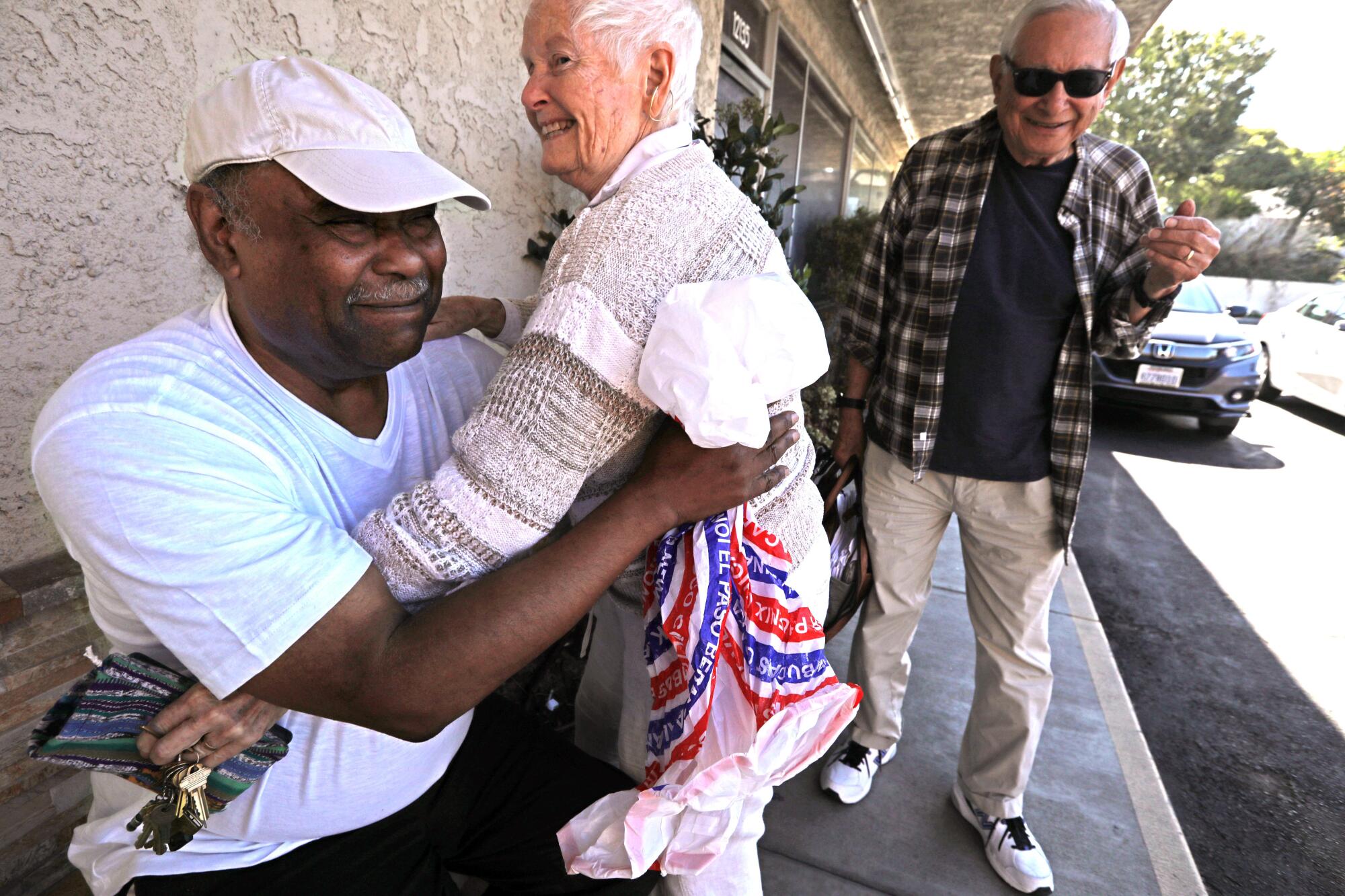 David Mays receives a hug of support from Betty Juarez in West Los Angeles