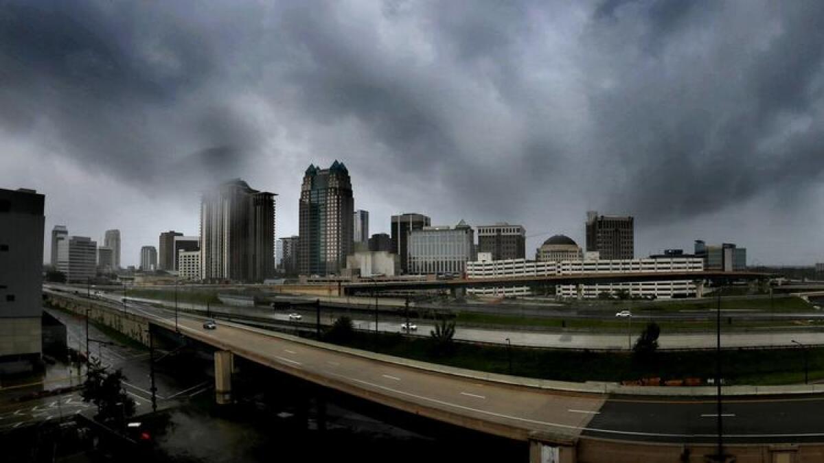 Storm clouds form over the skyline of downtown Orlando.